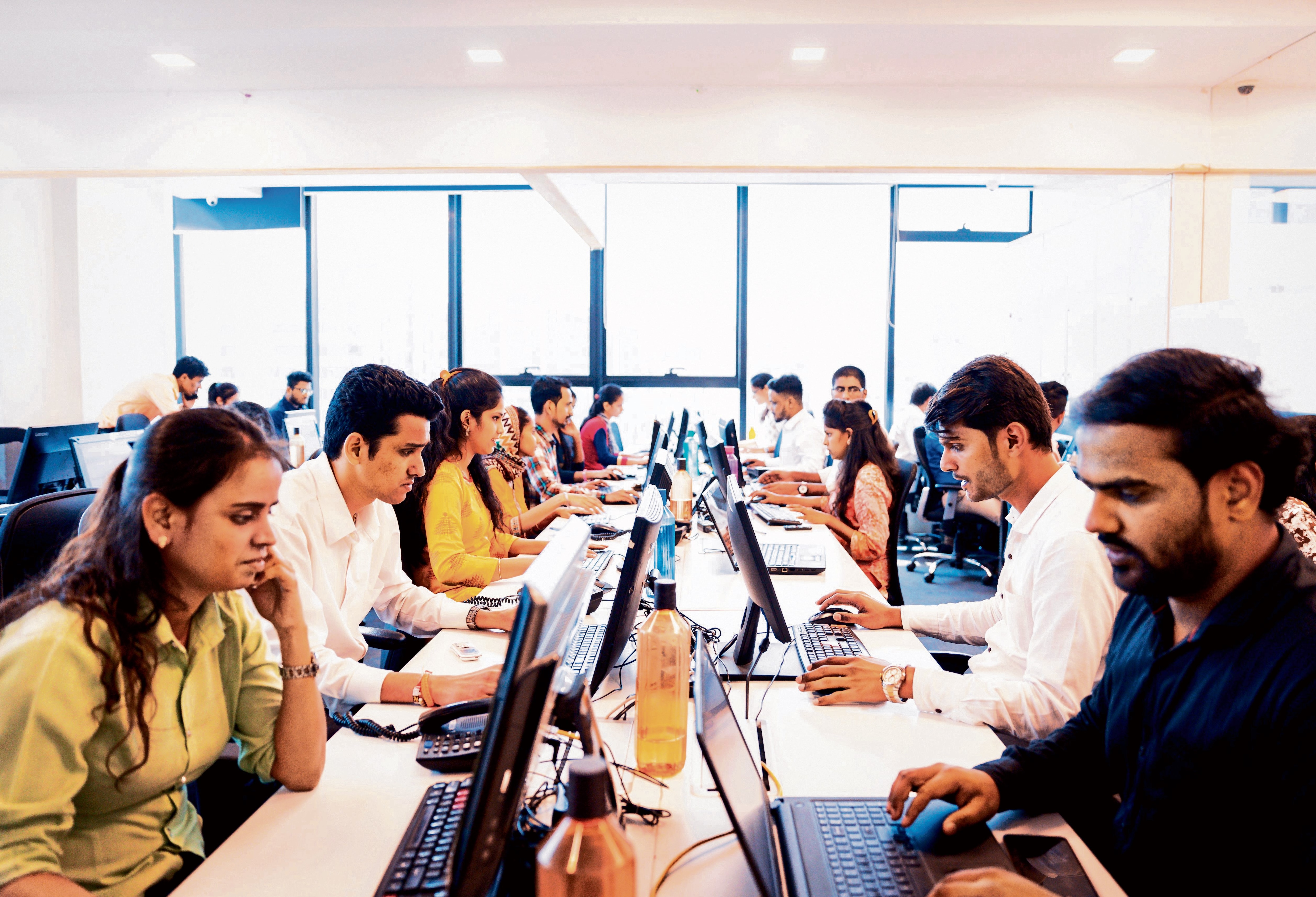 File photo of business executives working in a call centre.